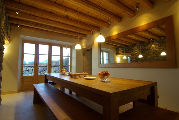 Custom bespoke Oak dining table with benches in a ski chalet, made in Sheffield.