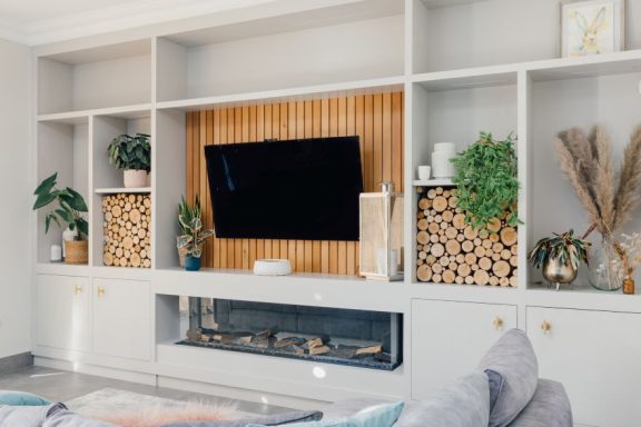 Bespoke media wall with cedar cladding behind a flat screen TV. Made in Sheffield by Phillip Davies.