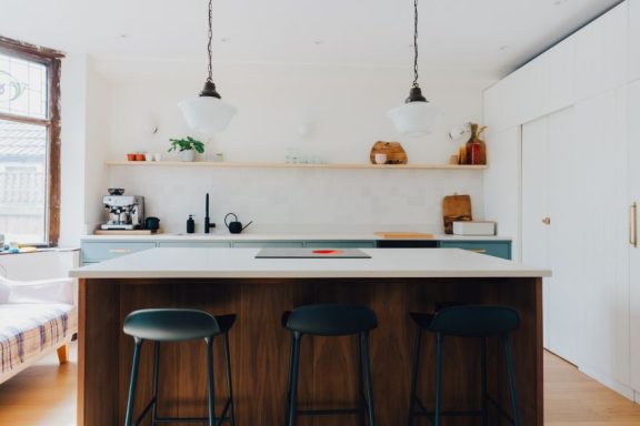 A luxury kitchen with a down draft hob set into a stone worktop.