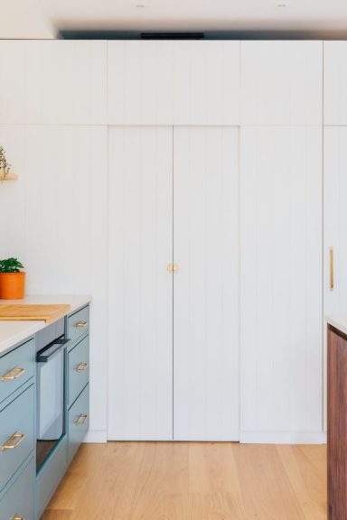 Handmade walk in kitchen pantry with handles from Corston hardware.