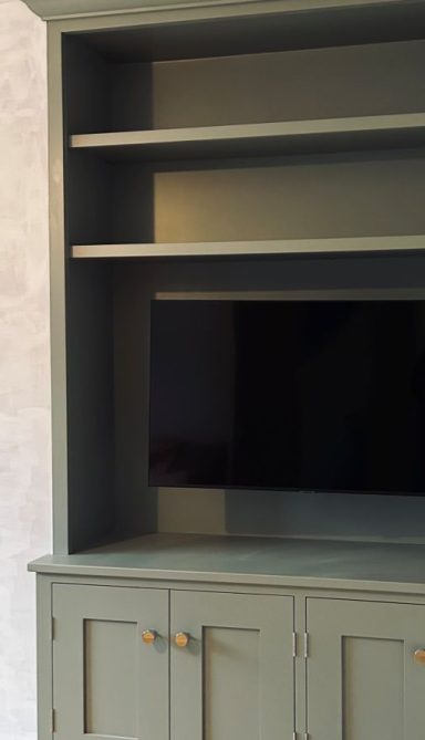 Bespoke alcove TV unit made from hardwood and painted with grey Farrow and Ball Paint. Made in Sheffield by Phillip Davies.