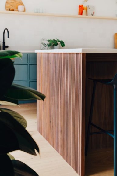A completely unique kitchen island with grooved American walnut end panels and doors.
