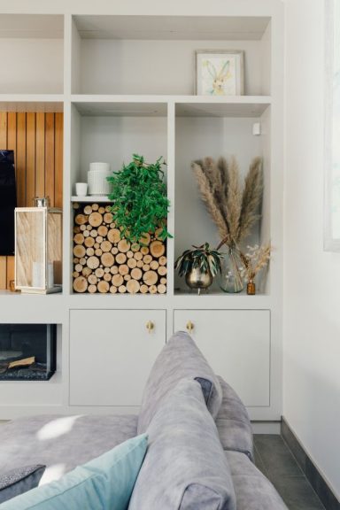 TV wall with cedar cladding and shelving around it. Bespoke furniture in Sheffield by Phillip Davies bespoke joinery.
