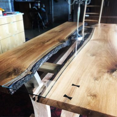 Beautiful luxury river table made in Sheffield from hardwood and glass. Bespoke furniture design by Phillip Davies.