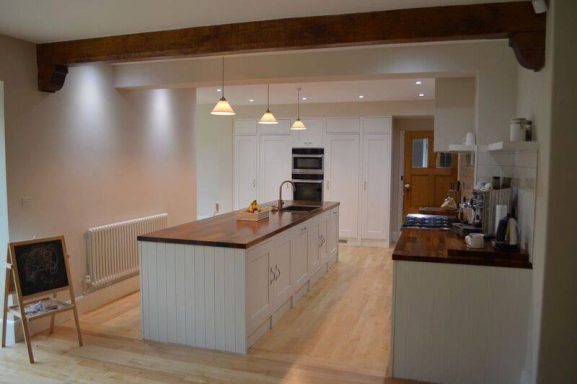 Bespoke kitchen island in white with Iroko worktops. Made by Phillip Davies bespoke joinery In Sheffield.