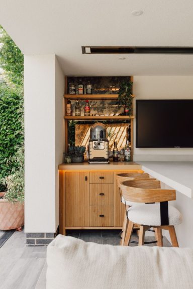 Outdoor kitchen bar made from oak with a mirrored back. Bespoke outdoor kitchen design in Sheffield.