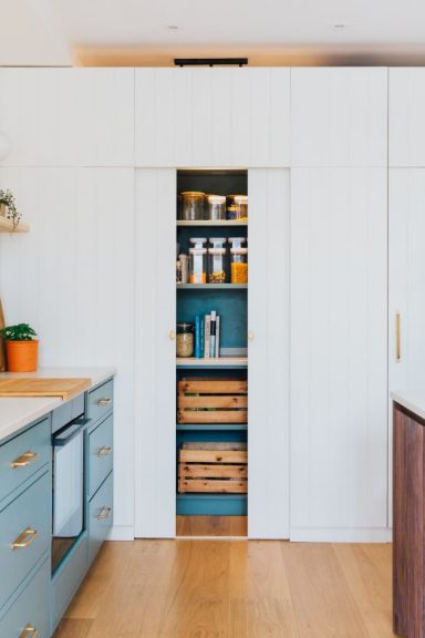 Bespoke walk in kitchen pantry unit with the doors open.