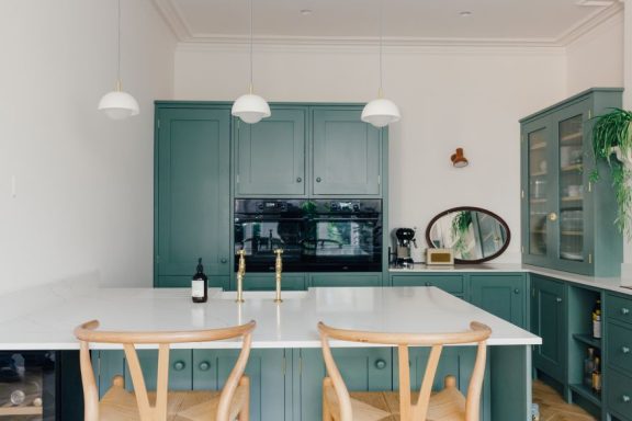 An exquisite handmade green shaker kitchen in Sheffield with bespoke trims.