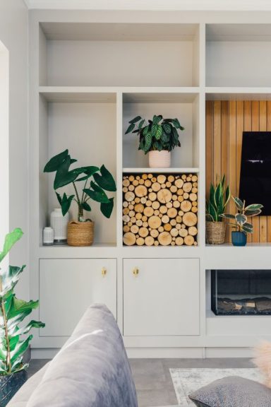 TV wall with cedar cladding and shelving around it. Bespoke furniture in Sheffield by Phillip Davies bespoke joinery.