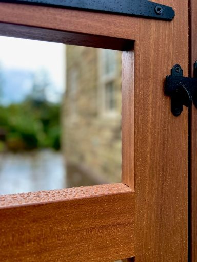 Bespoke hardwood gates made from Sapele with black ironmongery.